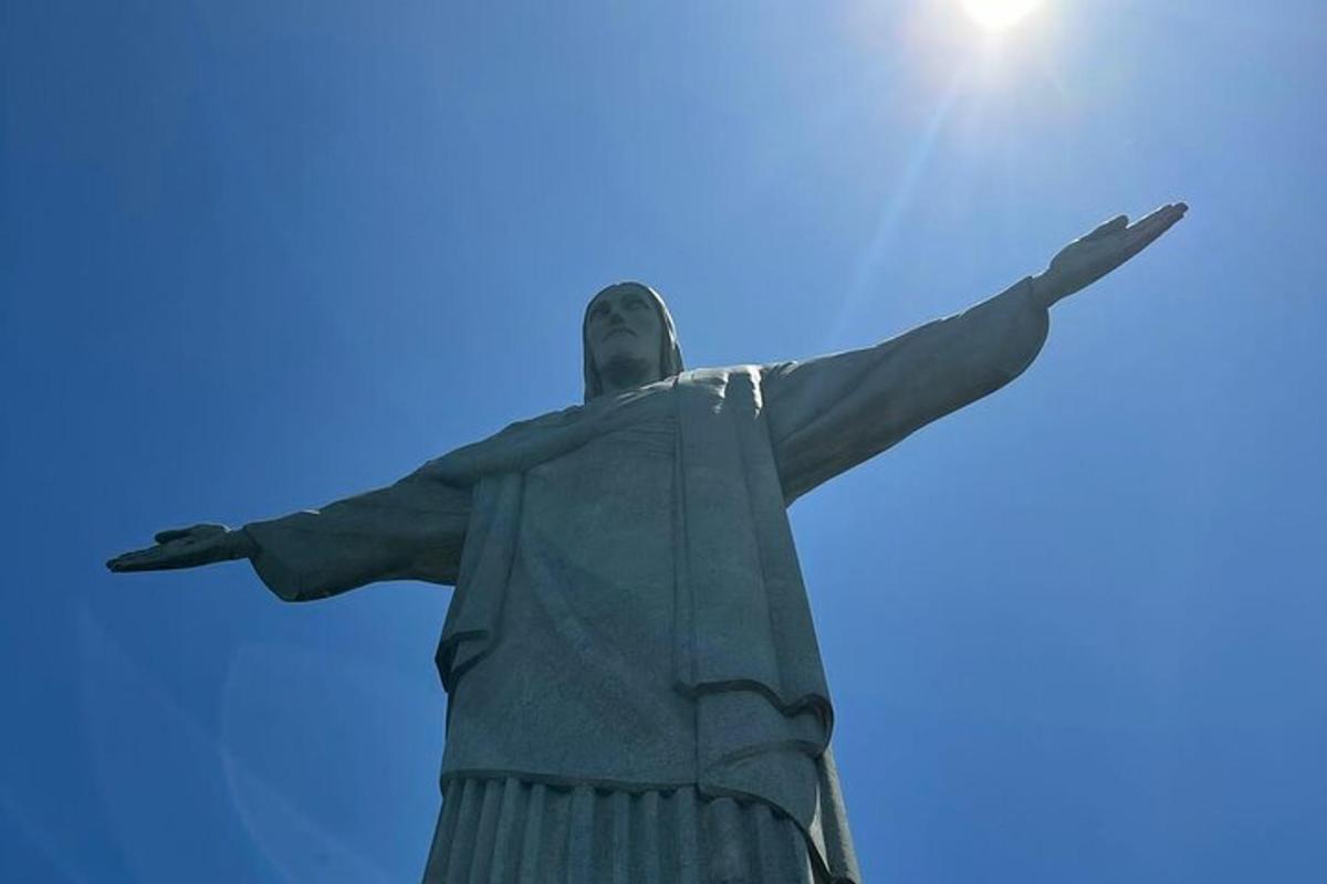 a statue of christ the redeemer against a blue sky