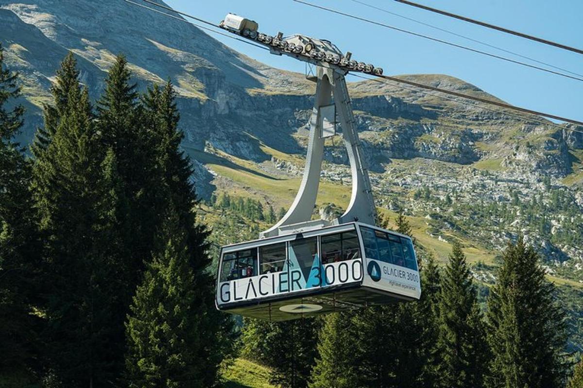 a gondola flying over a mountain