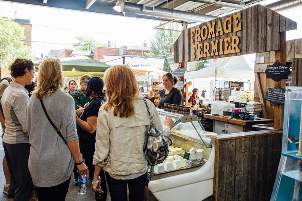 a group of people standing at a farmers market