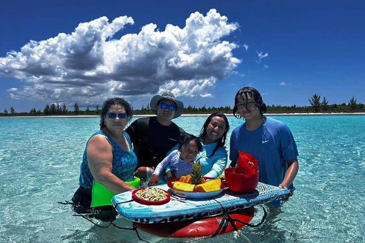 un gruppo di persone in acqua con un vassoio di cibo