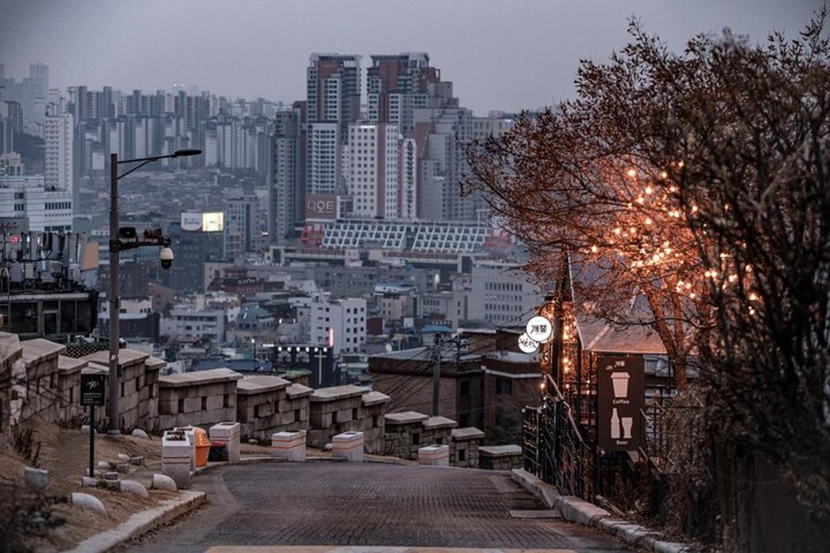 an empty street with a city in the background
