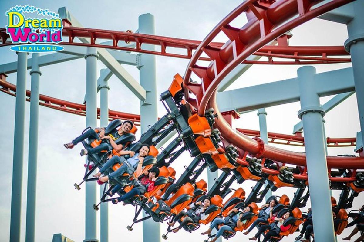 a group of people riding on a roller coaster at a theme park