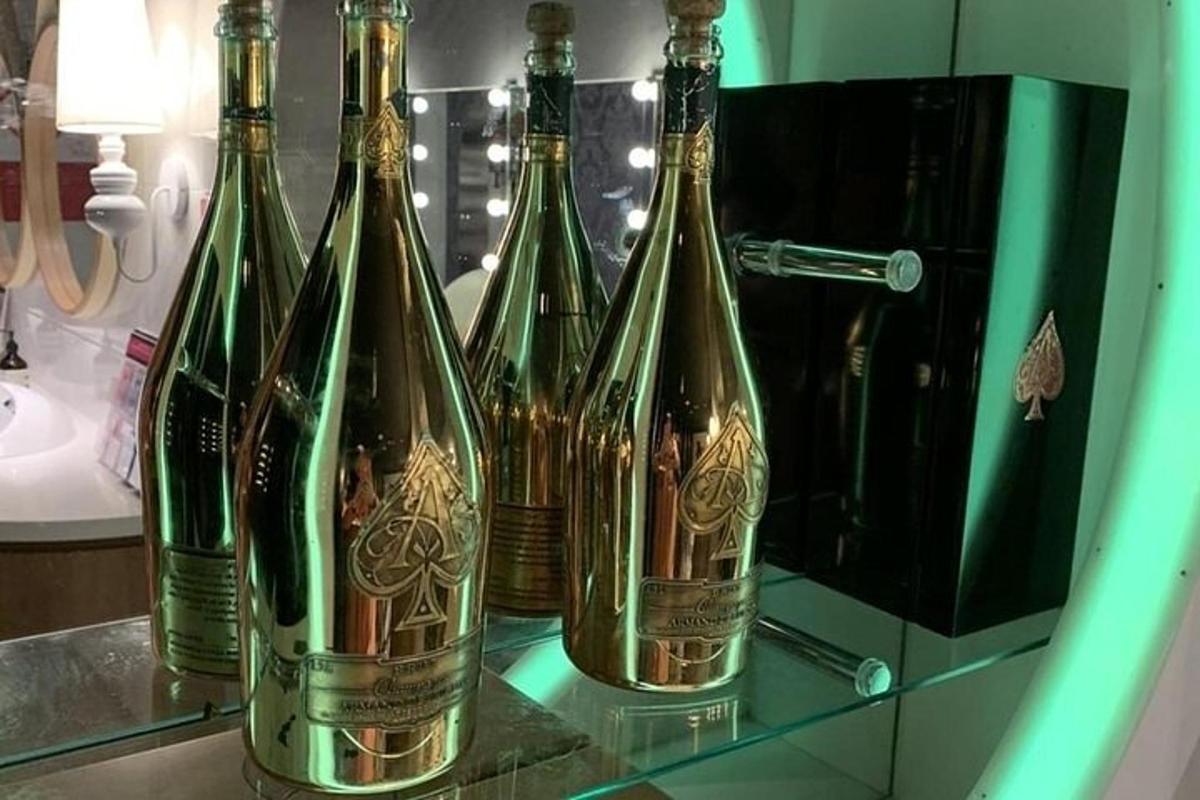 a group of wine bottles sitting on a shelf