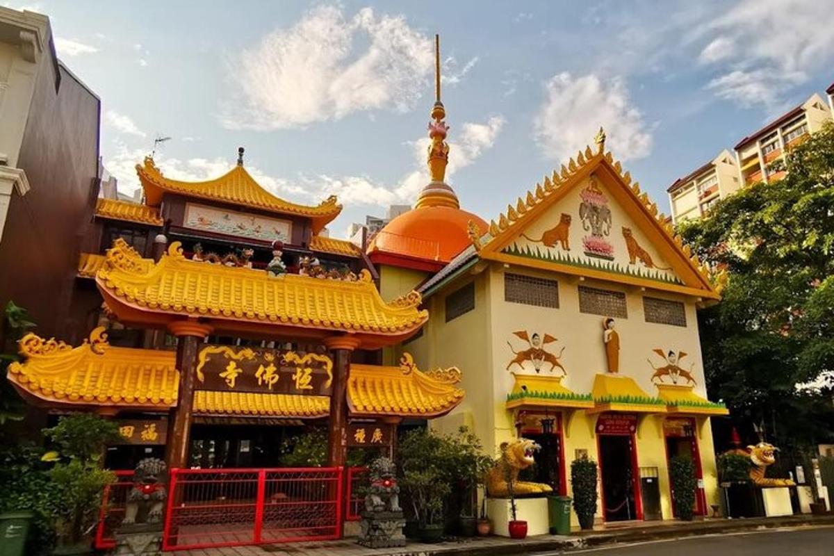 a yellow building with a yellow roof and a building