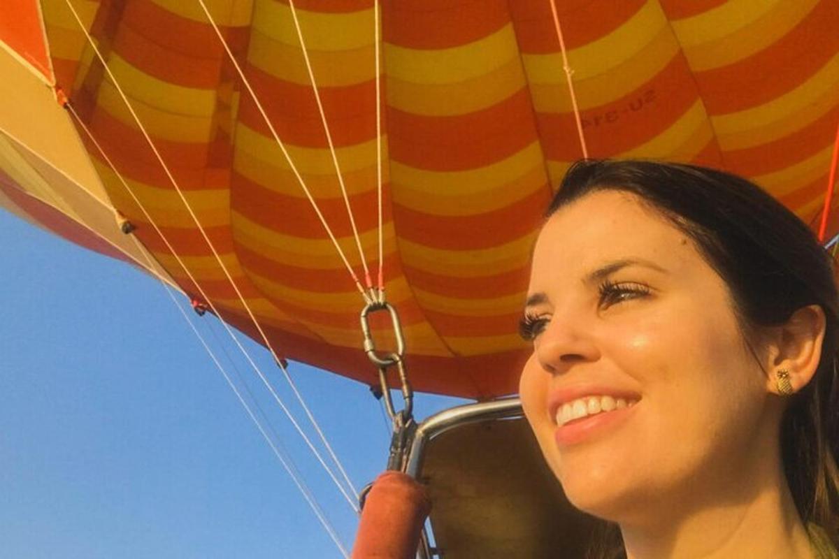 a woman is talking on a cell phone under a parachute