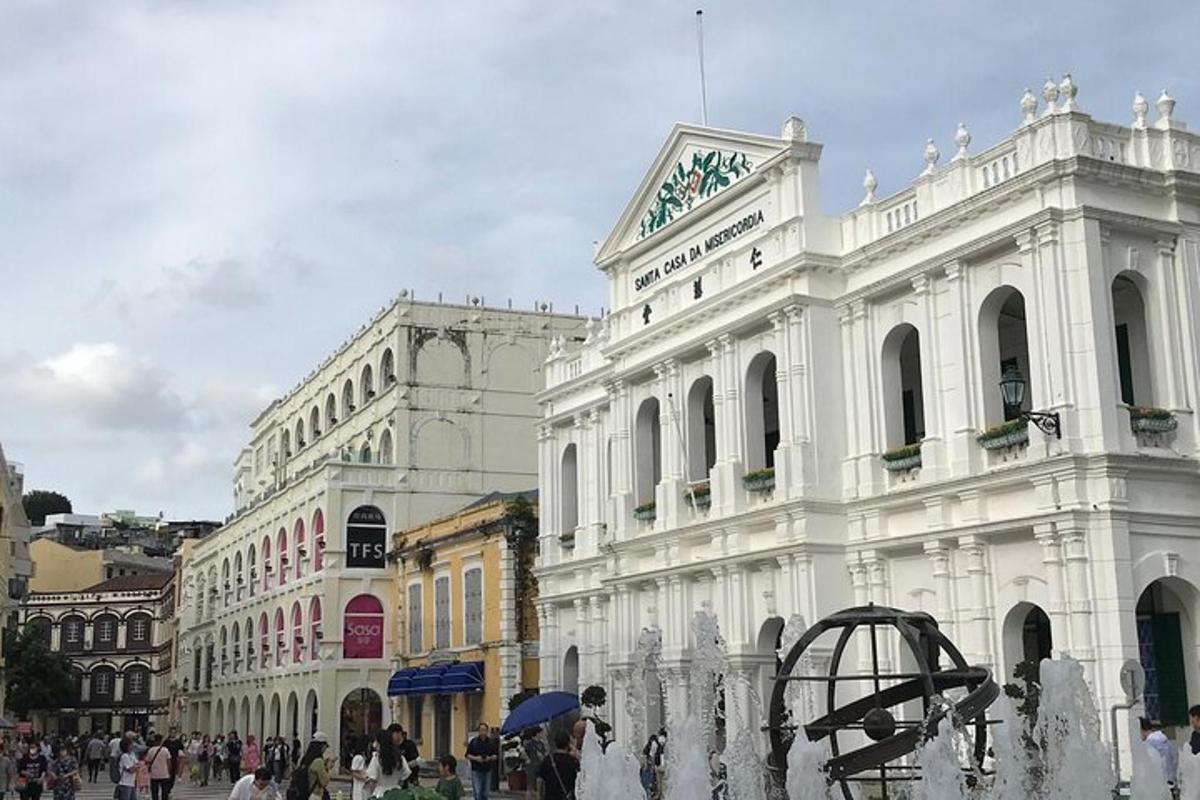 a white building with a fountain in front of it