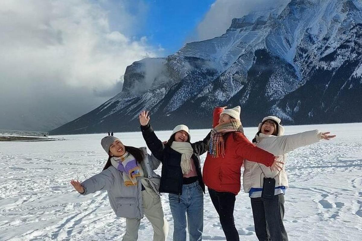 a group of women standing in front of a mountain