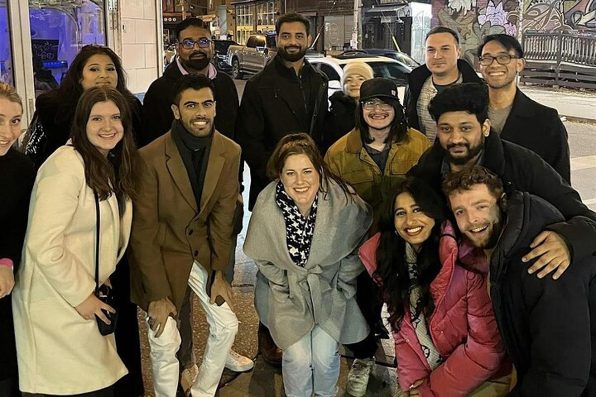 a group of people posing for a picture on a street