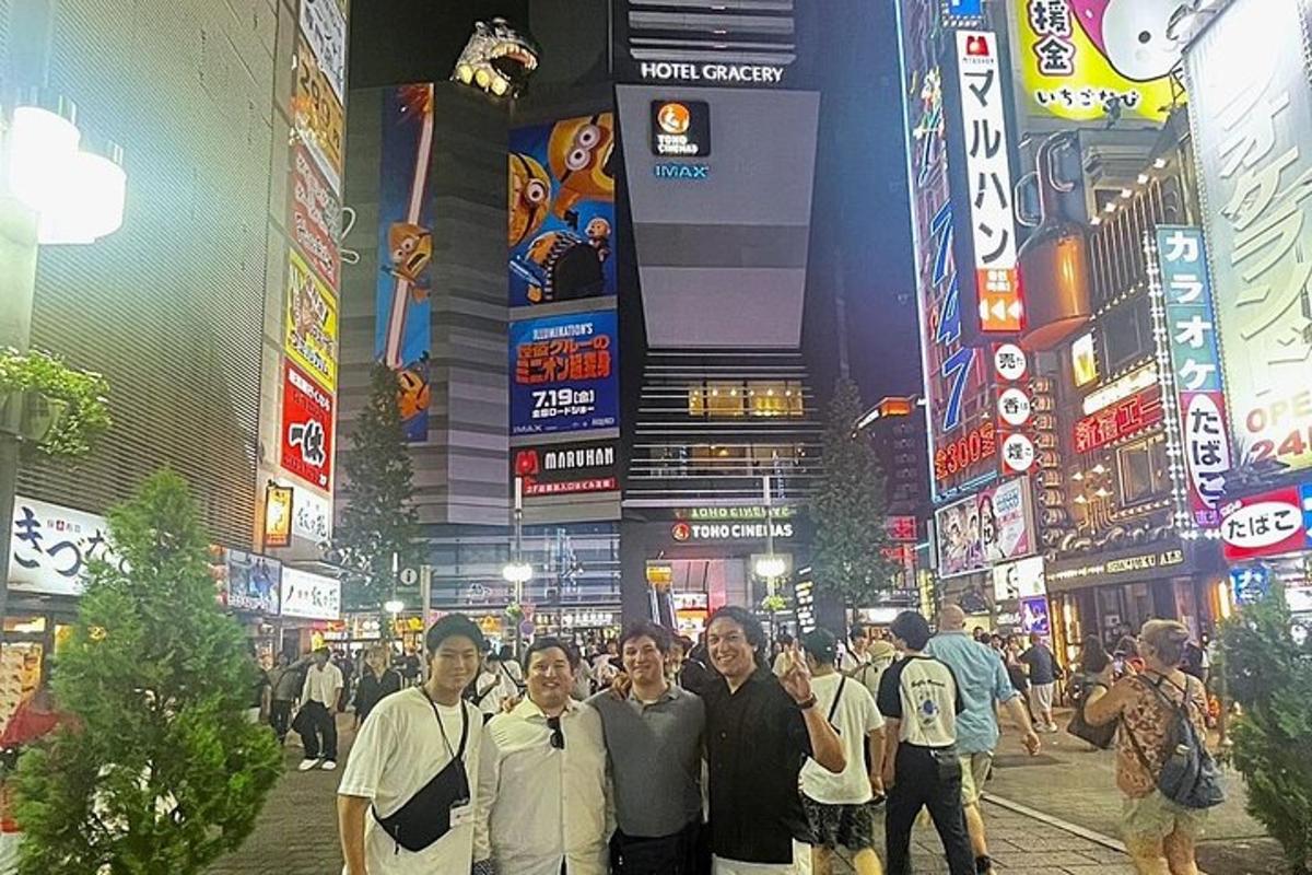 a group of people standing in a street at night