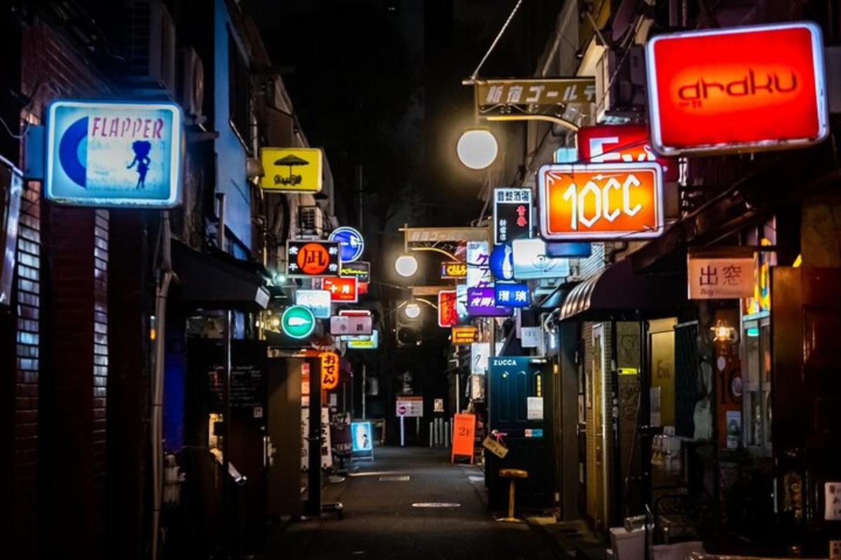 a city street at night with neon signs