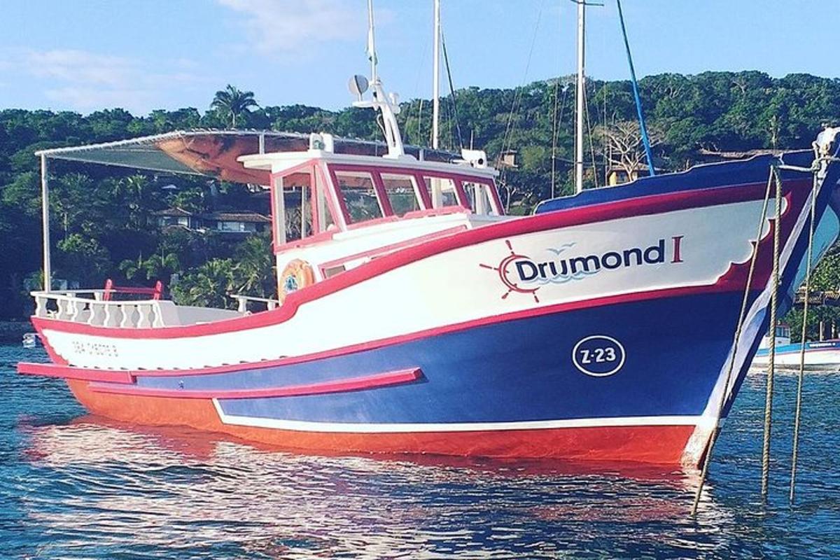 a red white and blue boat in the water