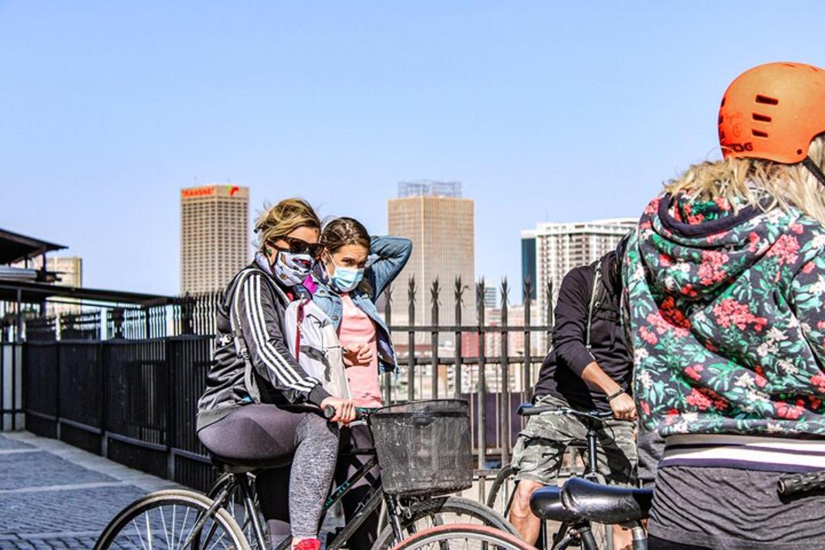 a group of people riding bikes on a bridge