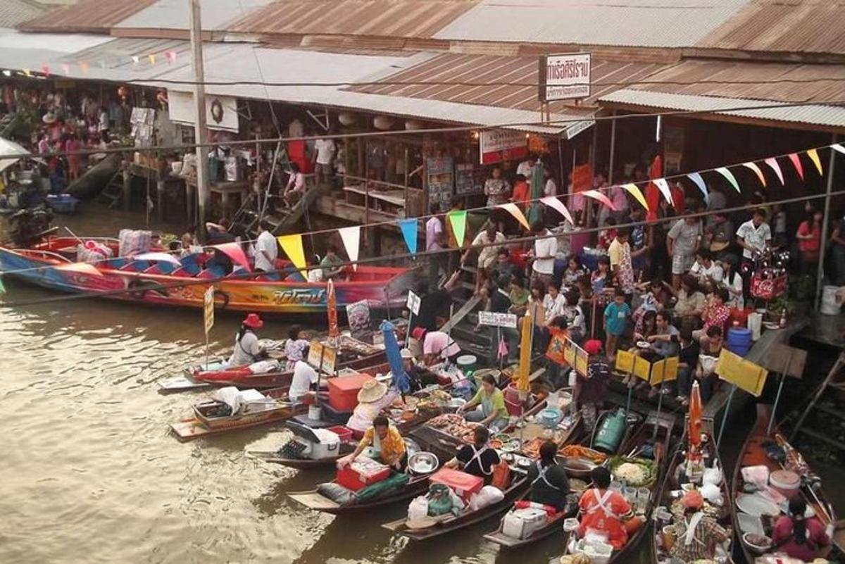 a group of people sitting in boats in the water