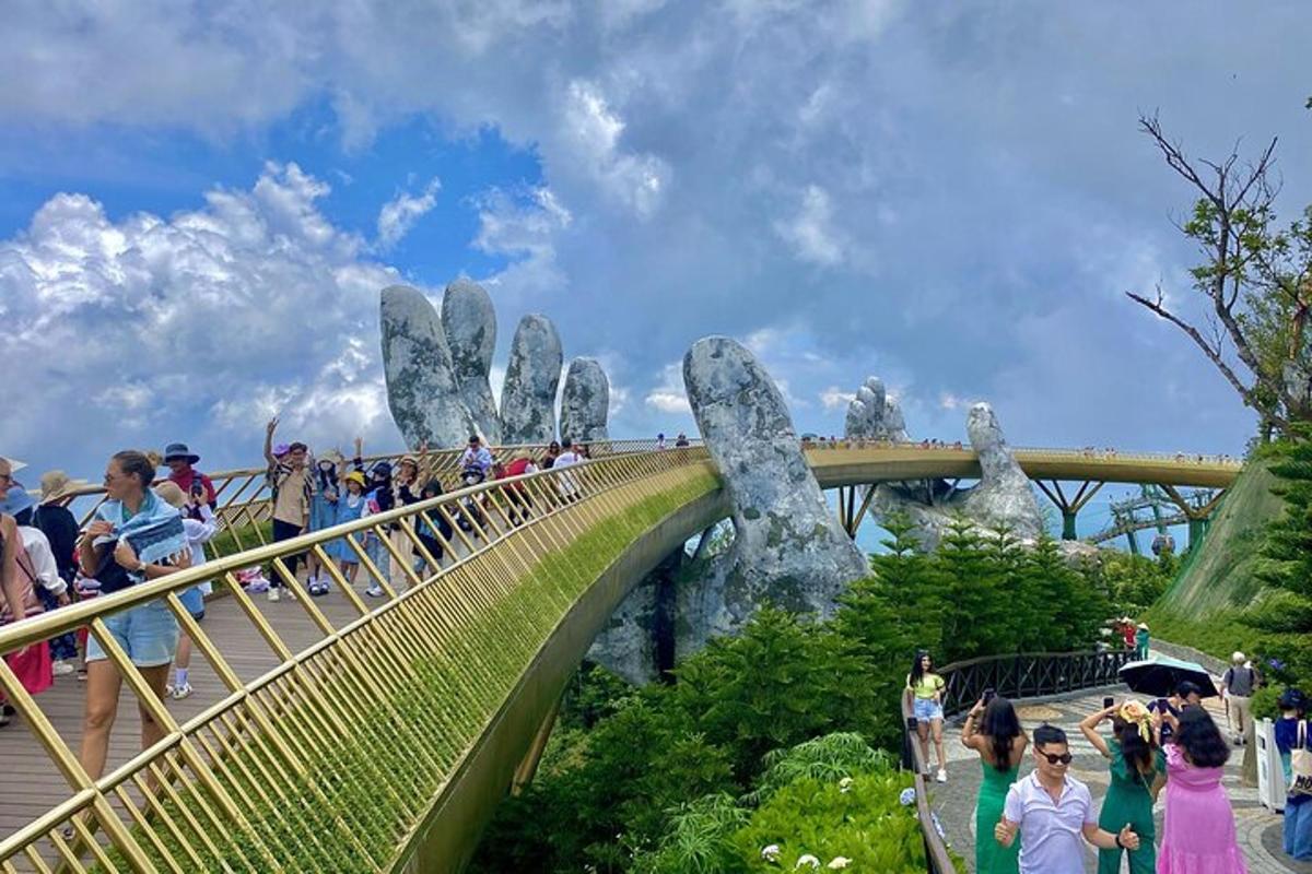 a group of people walking on a bridge with a hand bridge