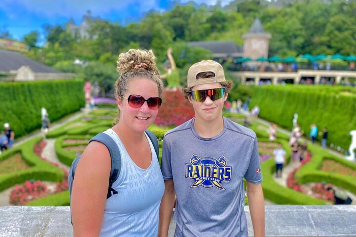 a man and a woman standing in front of a garden