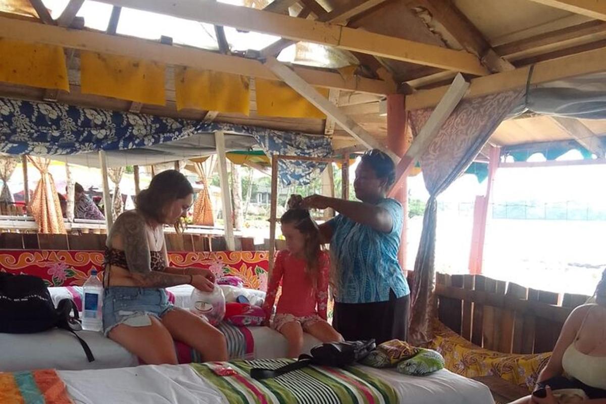 a group of people standing around a bed