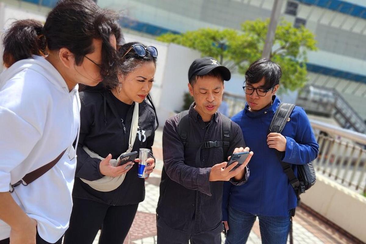 skupina lidí, kteří se dívají do svých mobilních telefonů