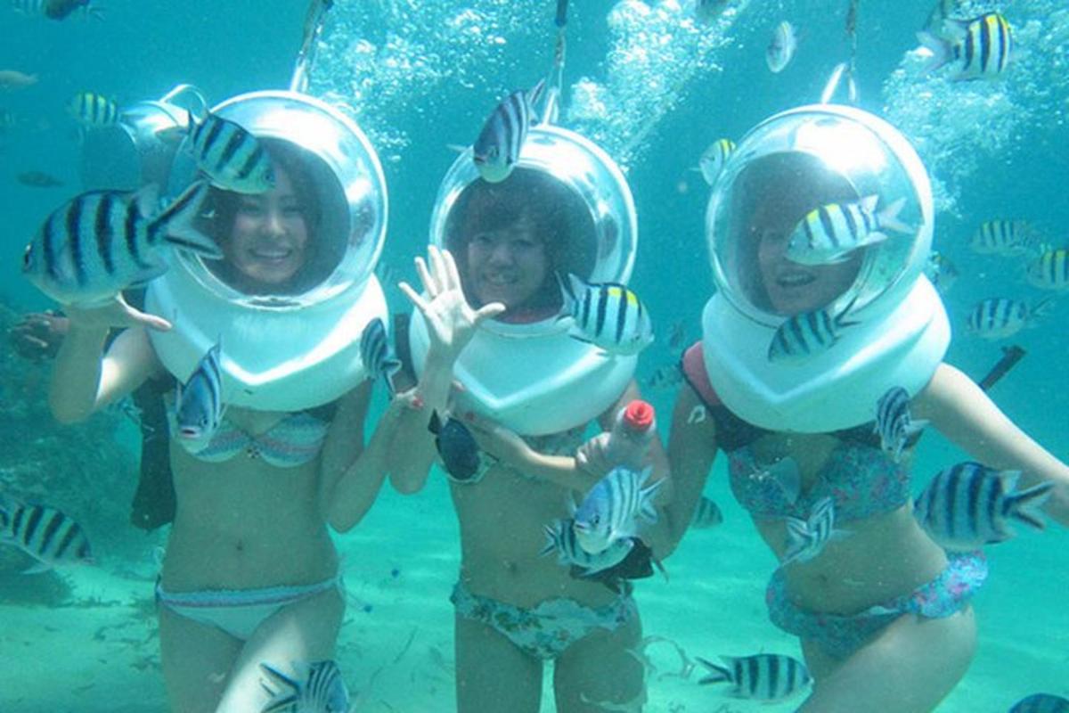 three girls in the water with food on their bikinis
