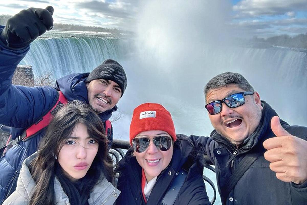 a group of people standing in front of a waterfall
