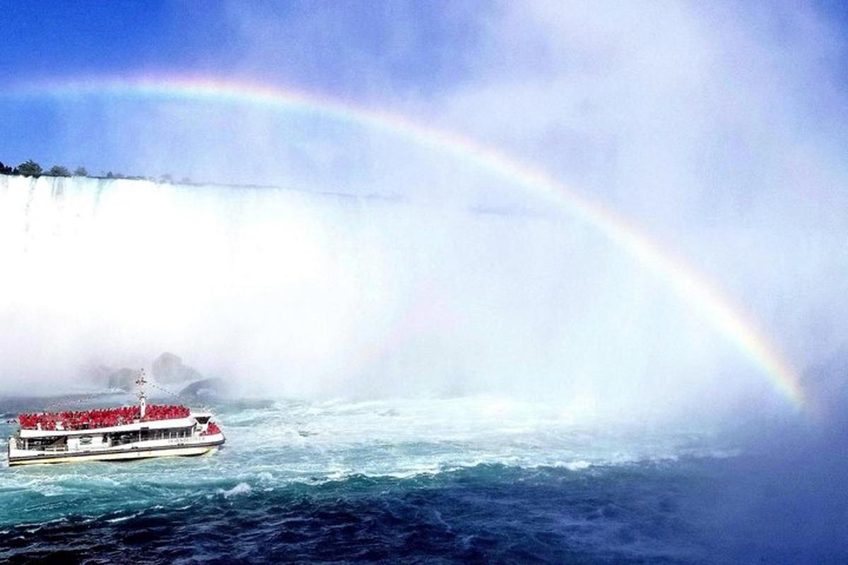 a double decker boat in front of a rainbow