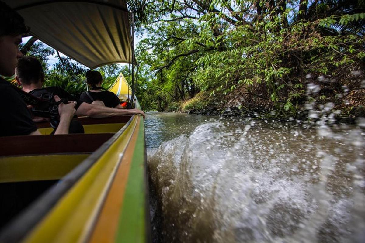 a group of people riding in a boat on a river