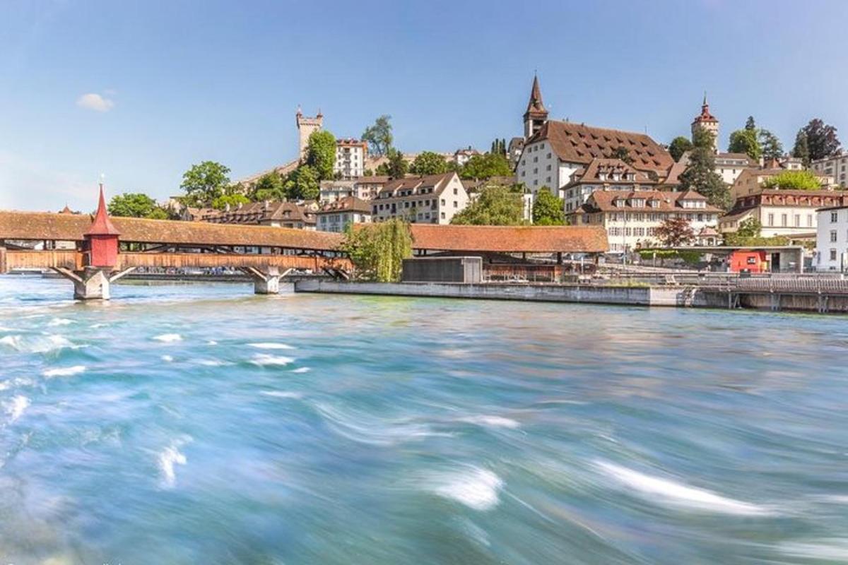 a river in front of a city with a bridge