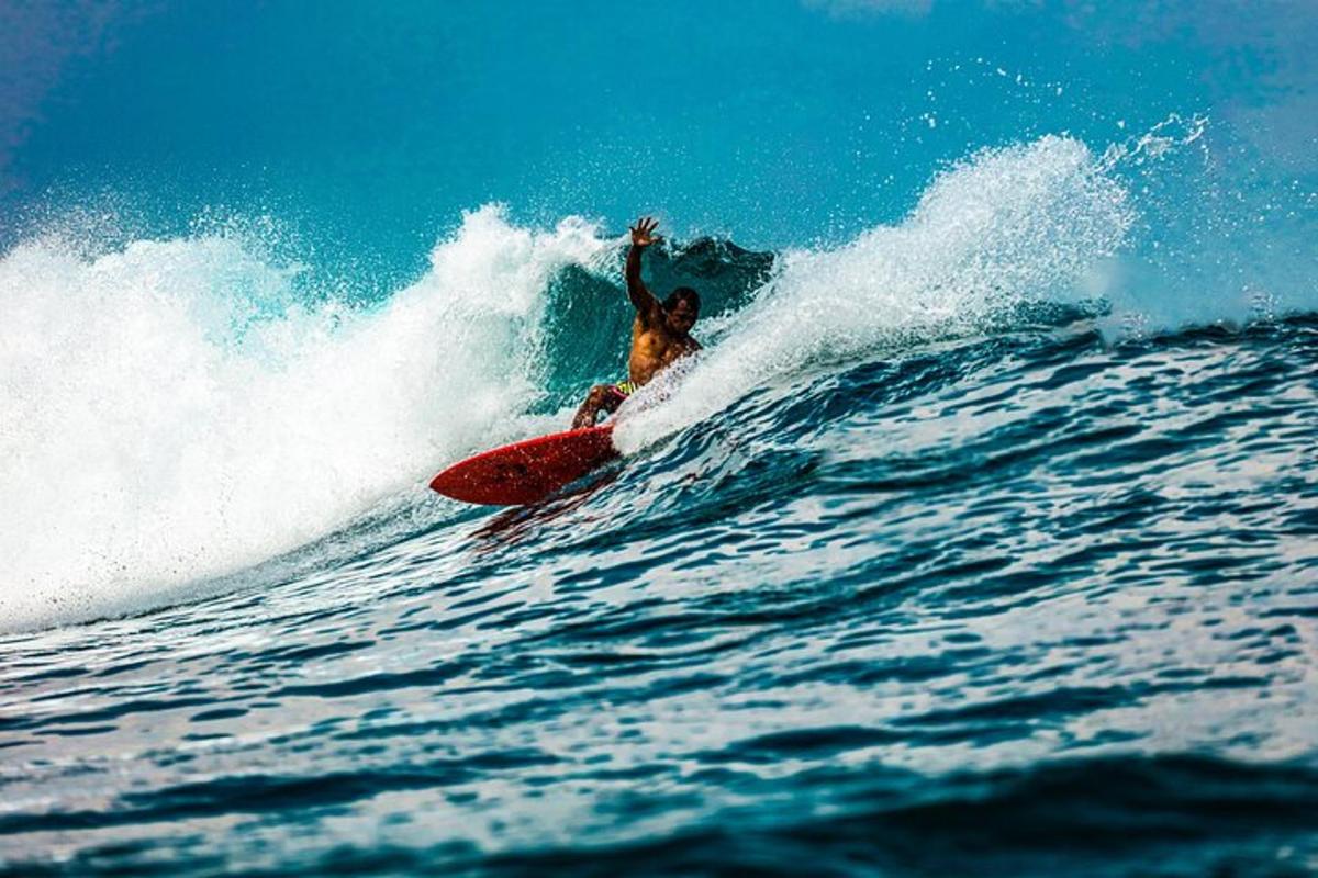 a man riding a wave on a surfboard in the ocean
