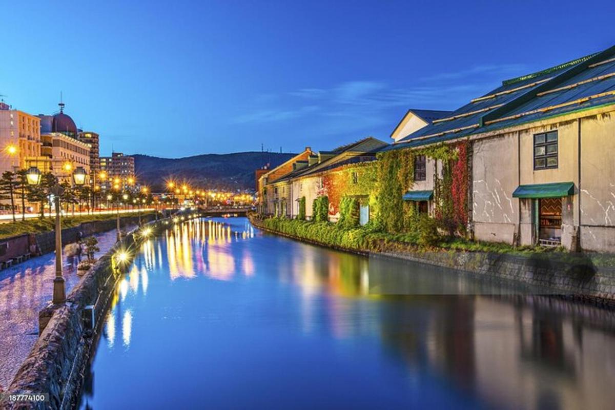 a view of a river with buildings and street lights