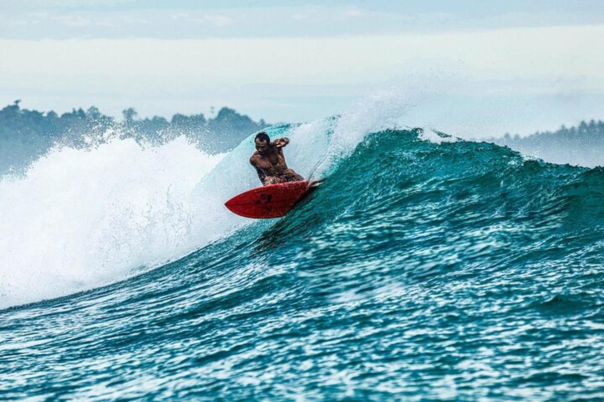 a man riding a wave on a surfboard in the ocean