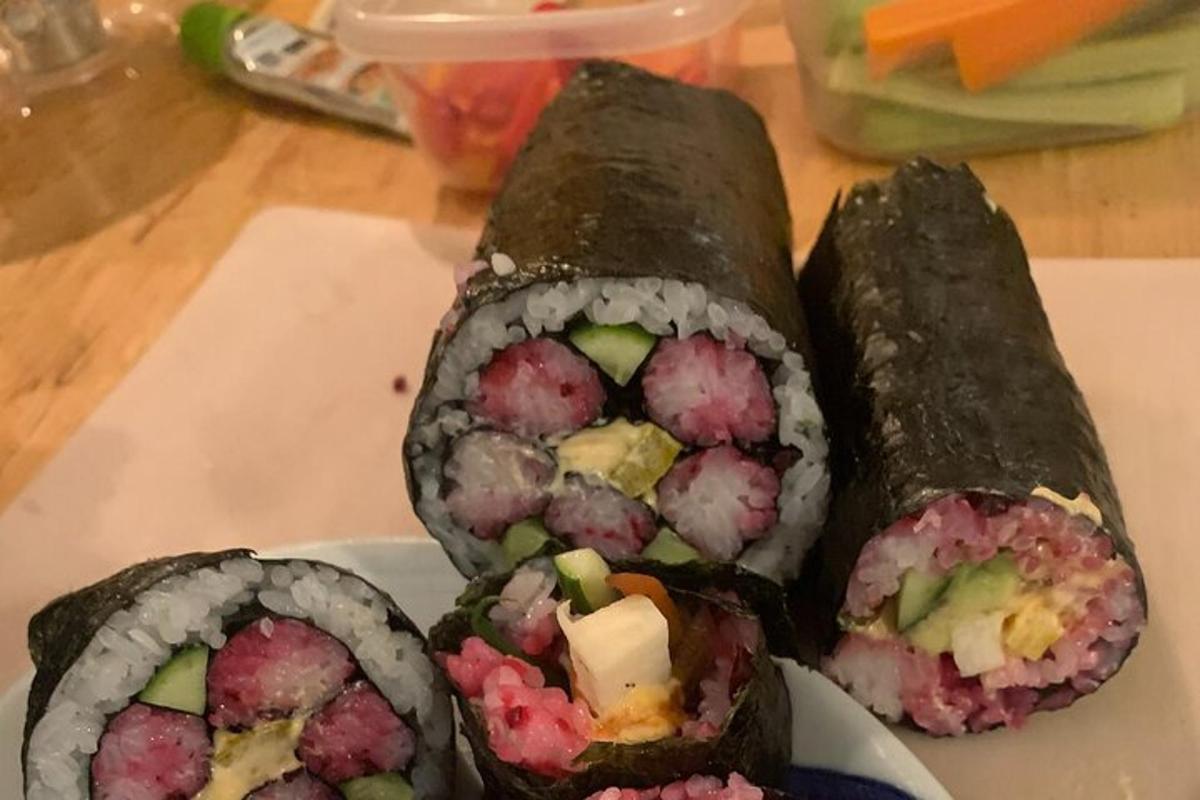three sushi rolls on a plate on a table