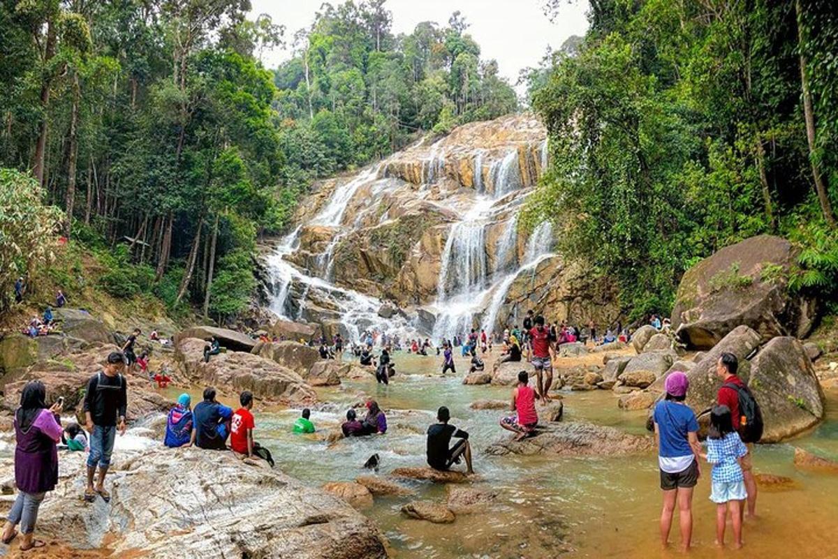 a group of people in a river with a waterfall