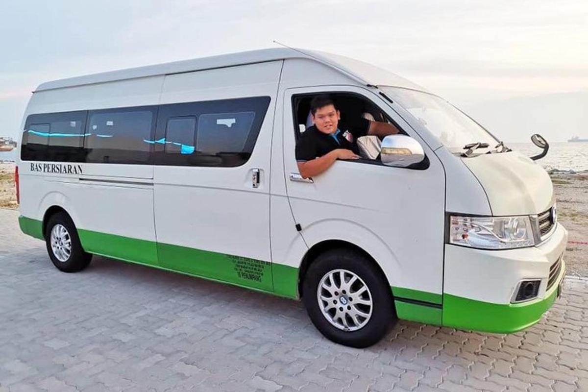 a man sitting in a white and green van