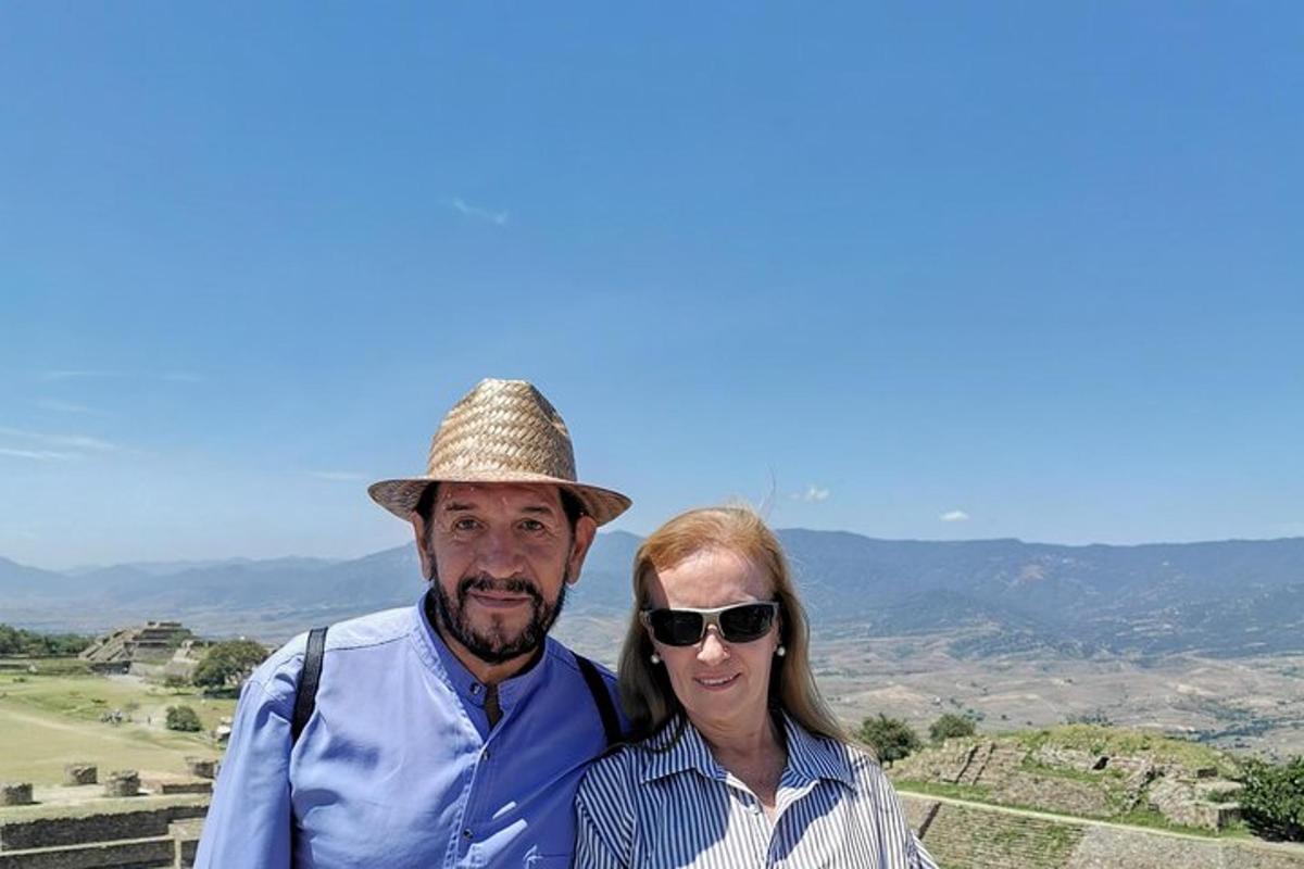 a man and a woman standing on top of a hill