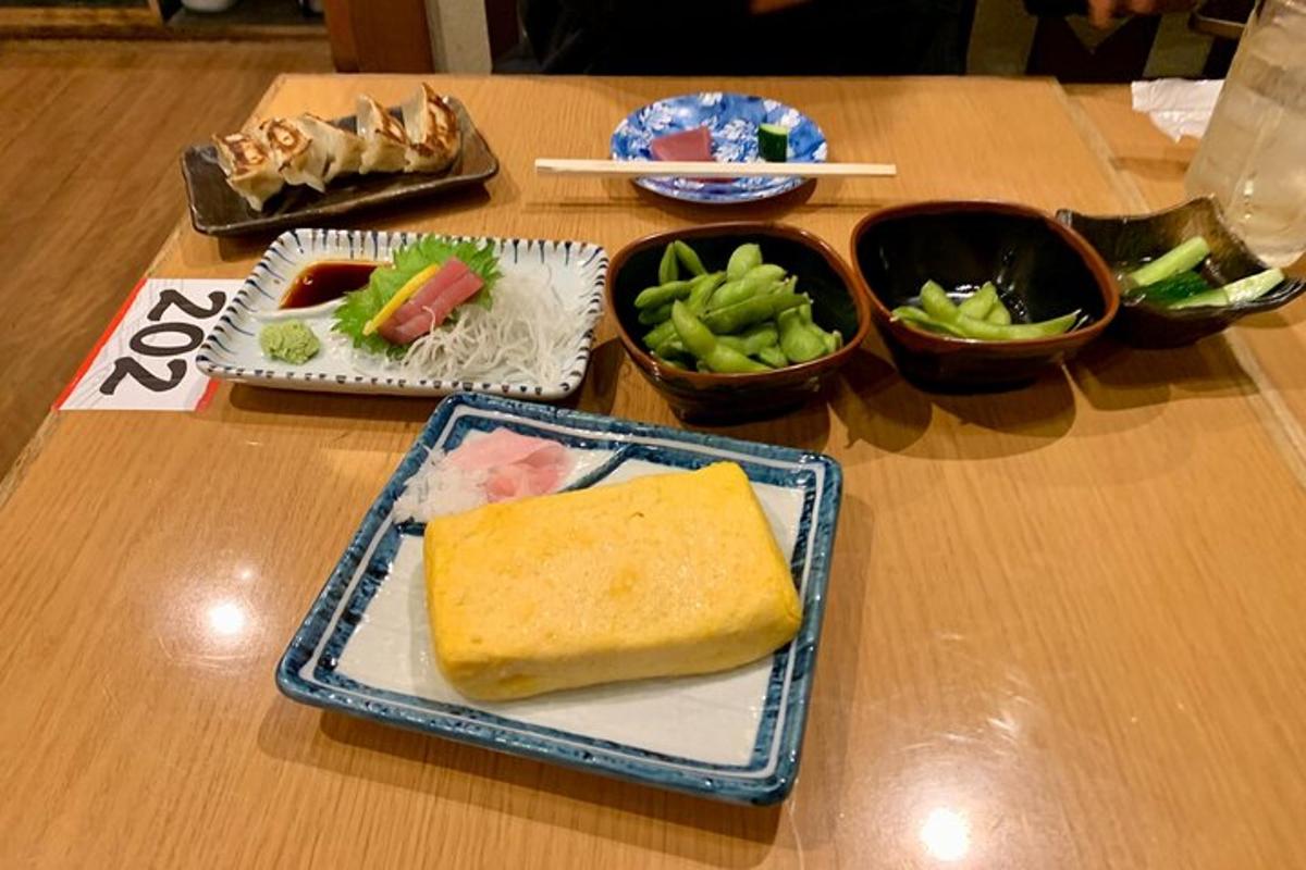 a table with a plate of food and bowls of vegetables