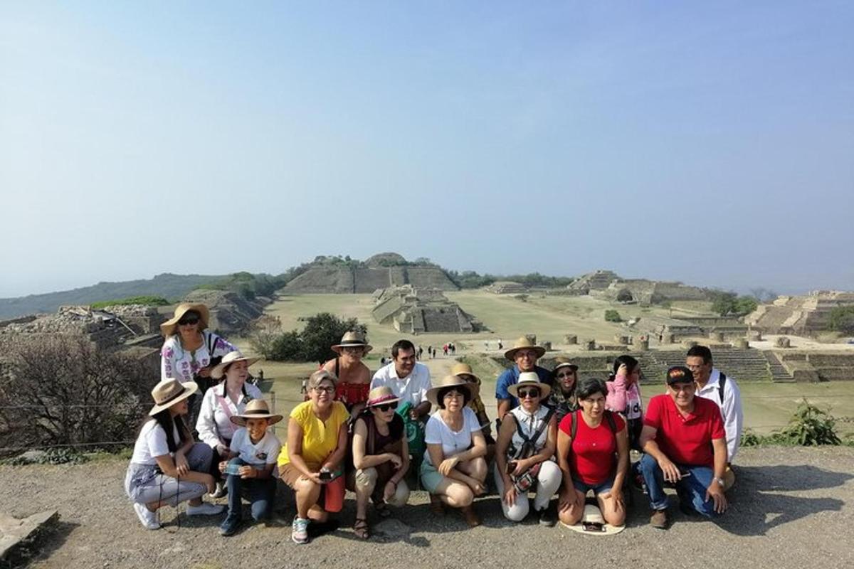 a group of people posing for a picture in front of the ruins
