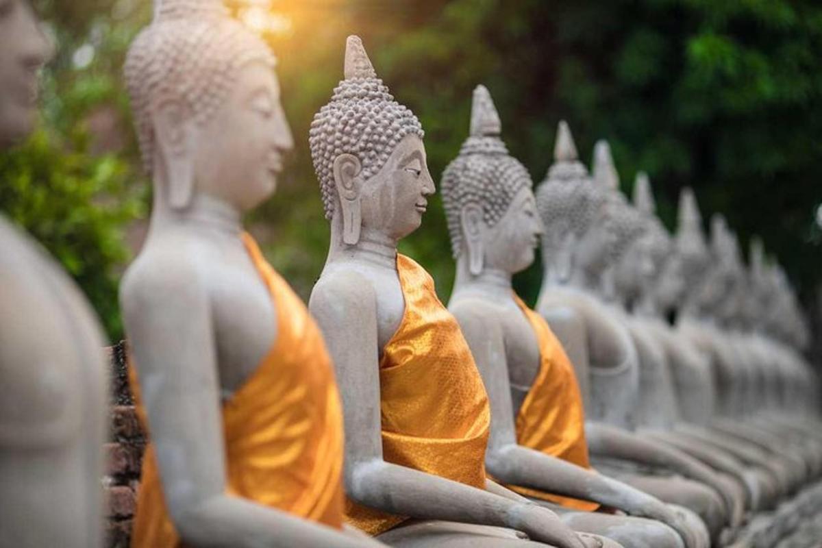 a row of monk statues sitting in a row