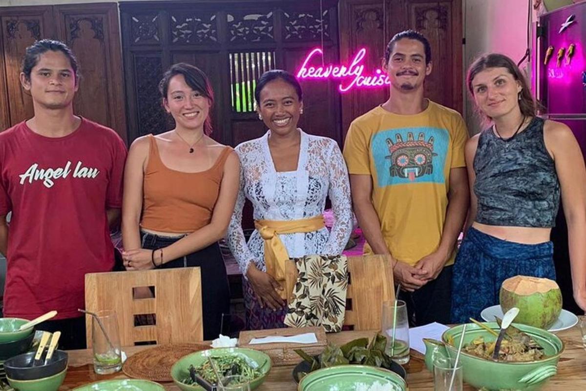 a group of people standing next to a table with food