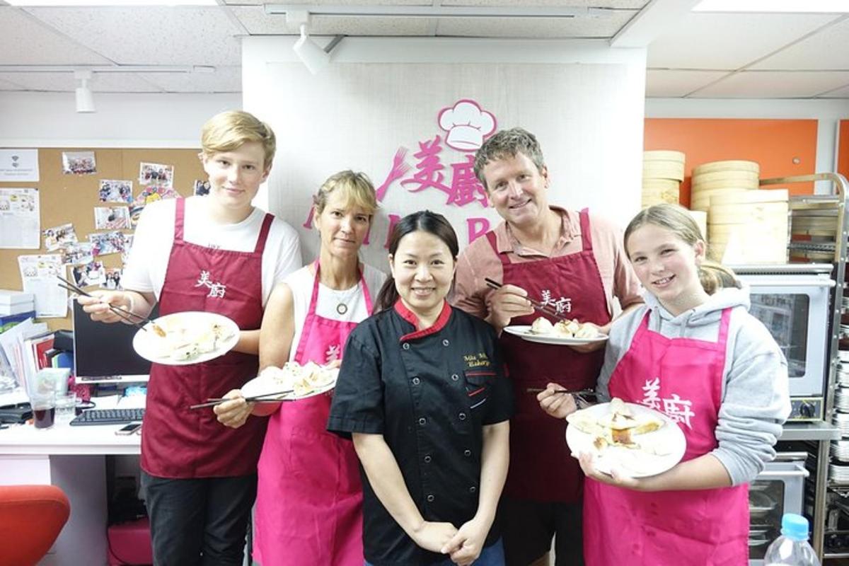 a group of people in a kitchen holding plates of food