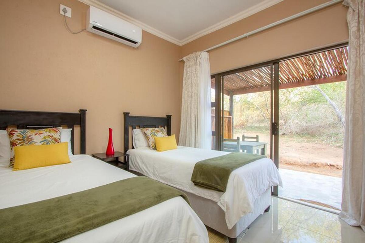 two beds in a room with a window