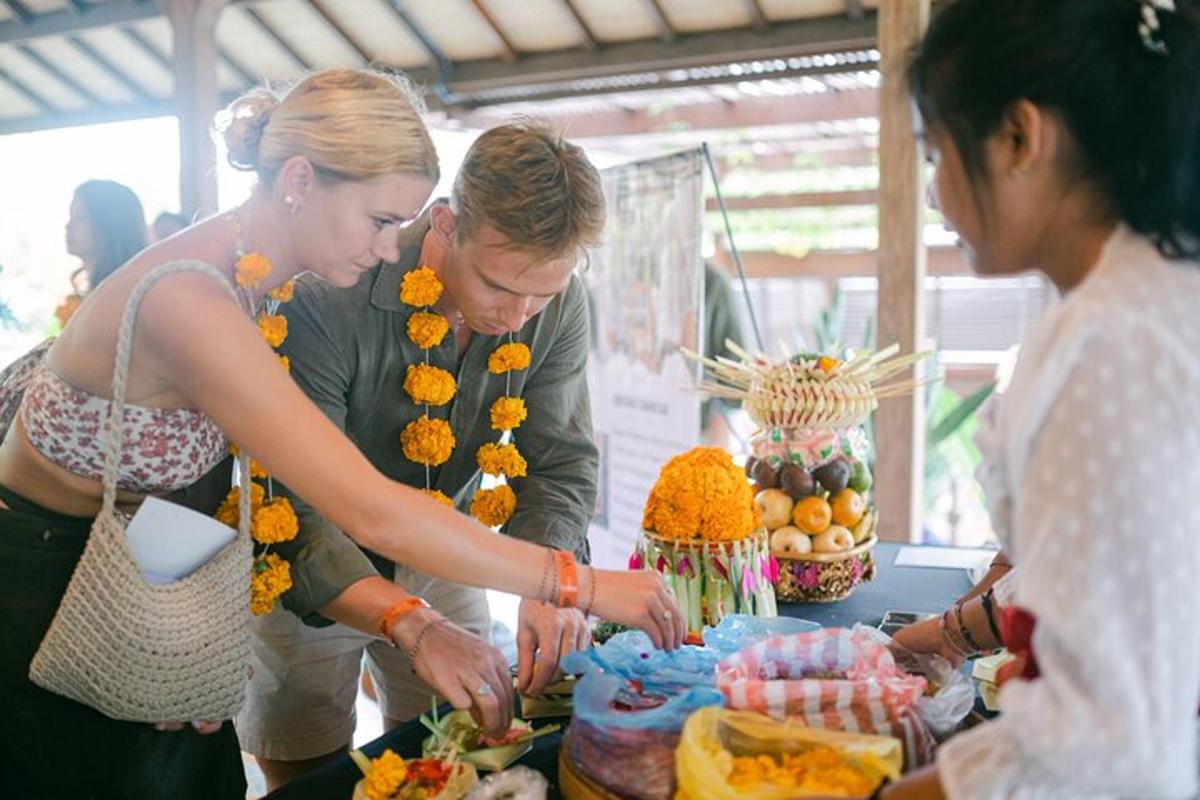 a man and two women standing around a table with a cake