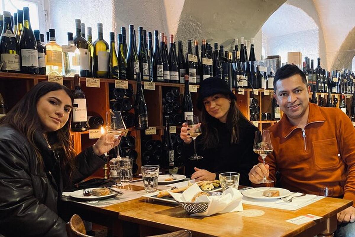 a group of people sitting at a table with wine glasses