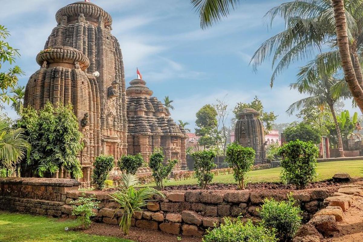 a temple in a park with palm trees and a stone wall