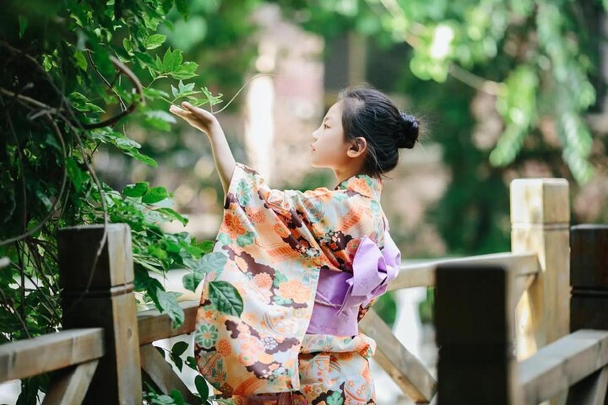 uma mulher de quimono pegando uma planta