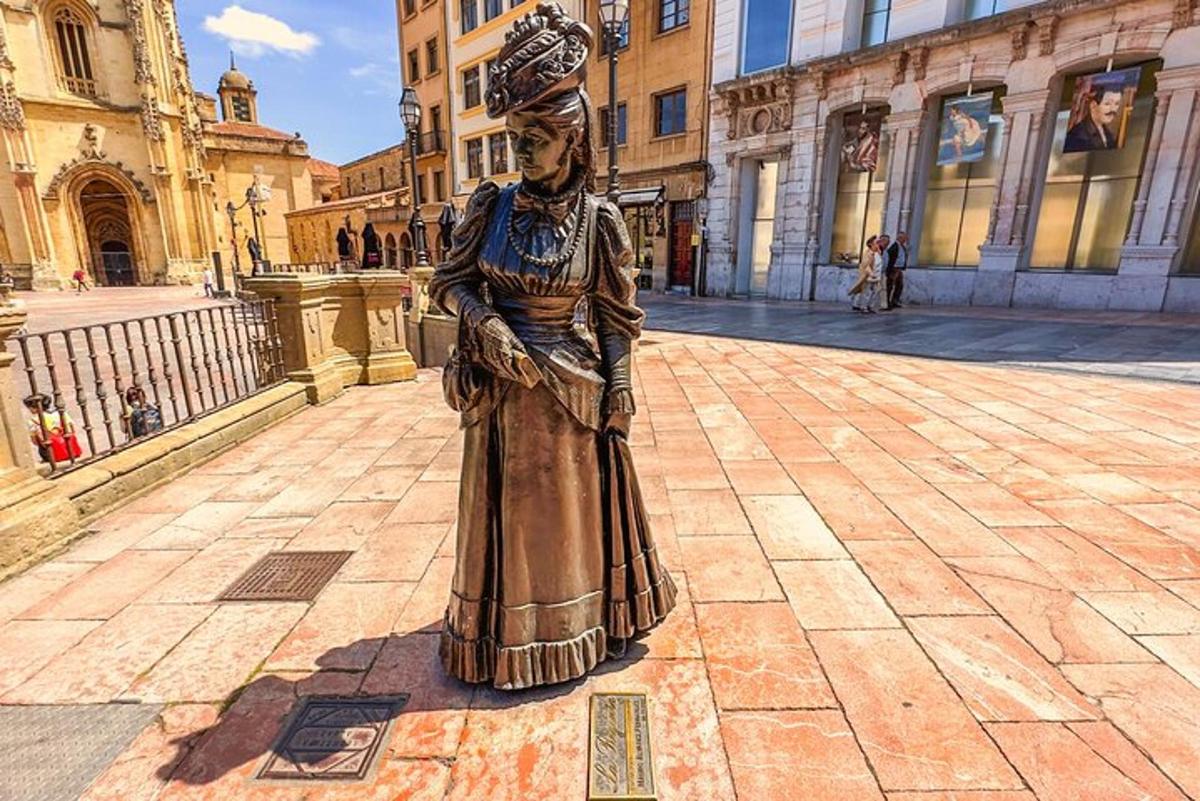 a statue of a woman in a dress on a street