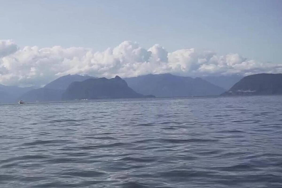 a large body of water with mountains in the background