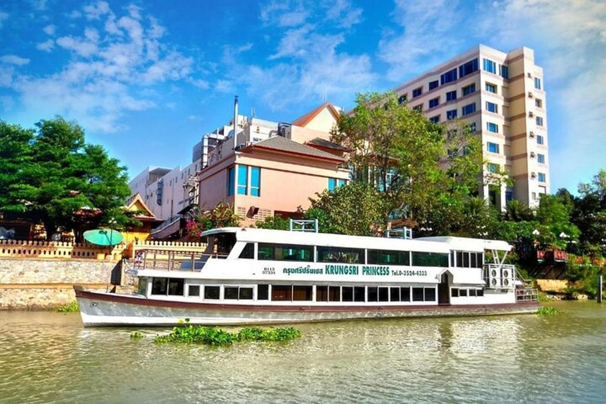 a boat on a river in front of a building