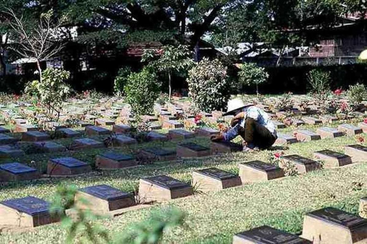 una persona seduta davanti a un cimitero