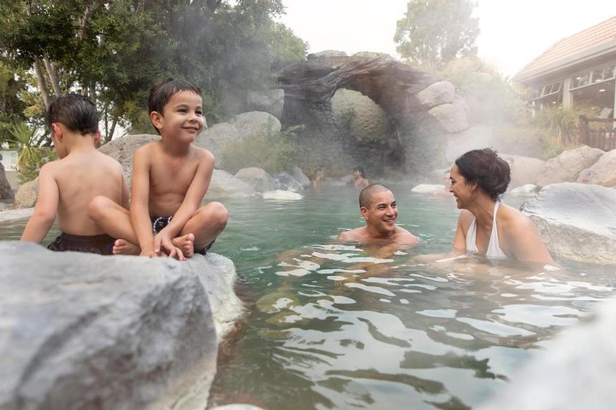 a group of people in the water at a zoo