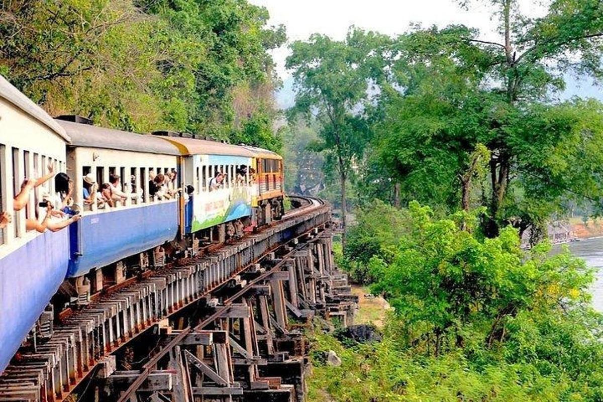Un tren en un puente con gente viajando en él.