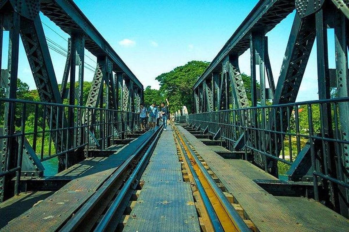 a bridge over a river with people walking on it